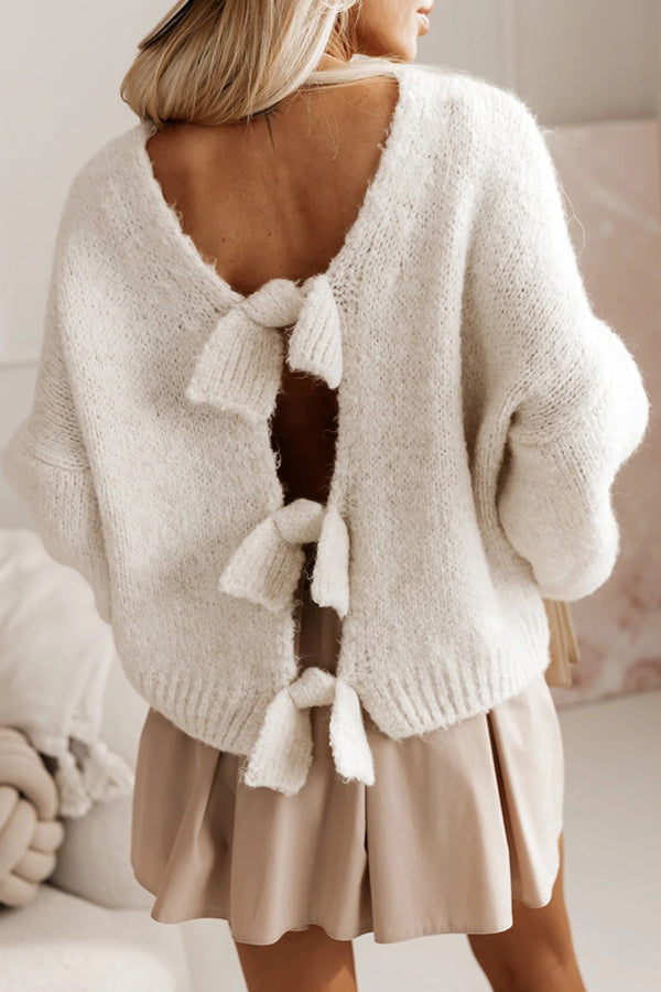 Cozy knit sweater with an open back and bow.
