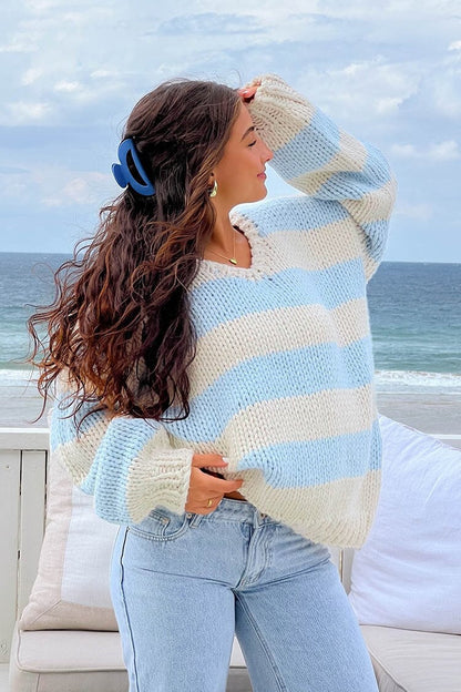 Cozy striped knit sweater with off-the-shoulder design. Chic autumn sweater. 