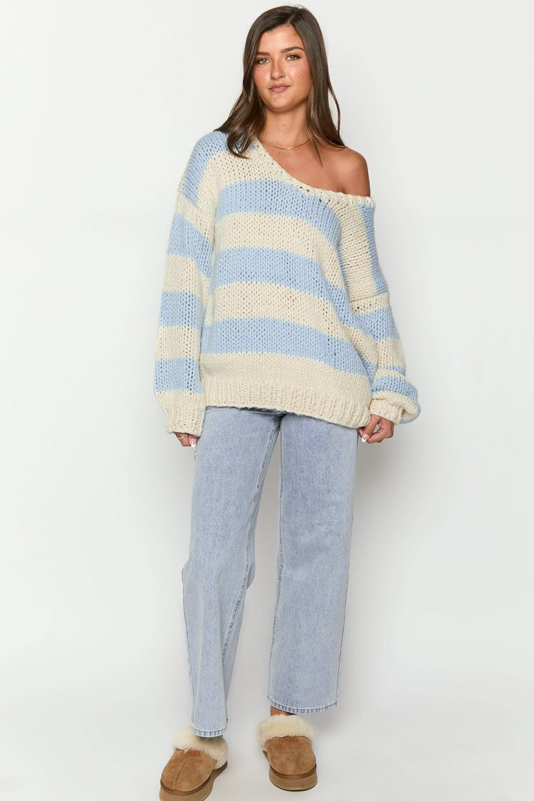 Cozy striped knit sweater with off-the-shoulder design. Chic autumn sweater. 