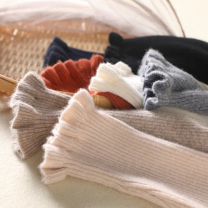 Cozy roll-neck sweater with feminine ruffle details 