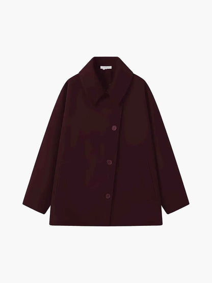 Oversized women's winter coat with lapel collar and asymmetrical buttons 