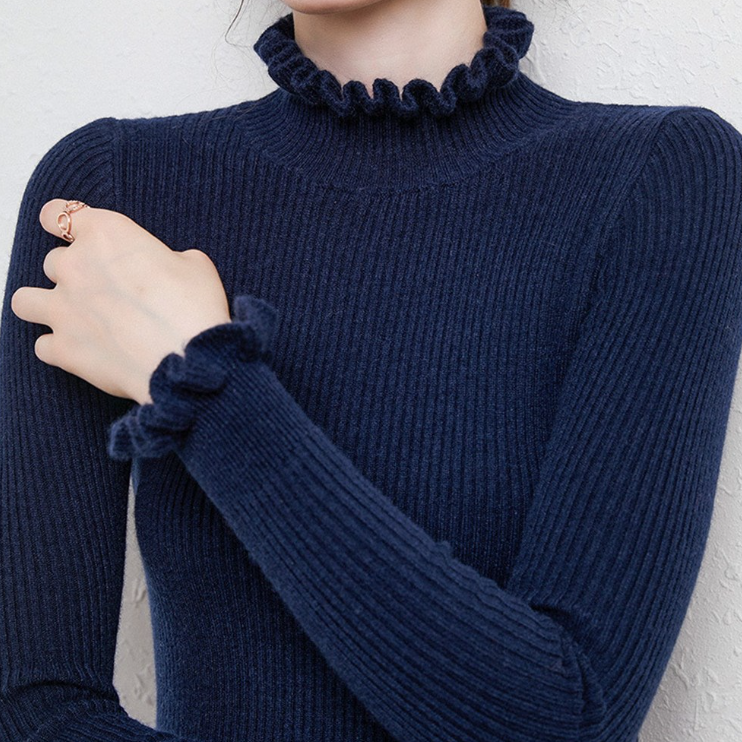 Cozy roll-neck sweater with feminine ruffle details 
