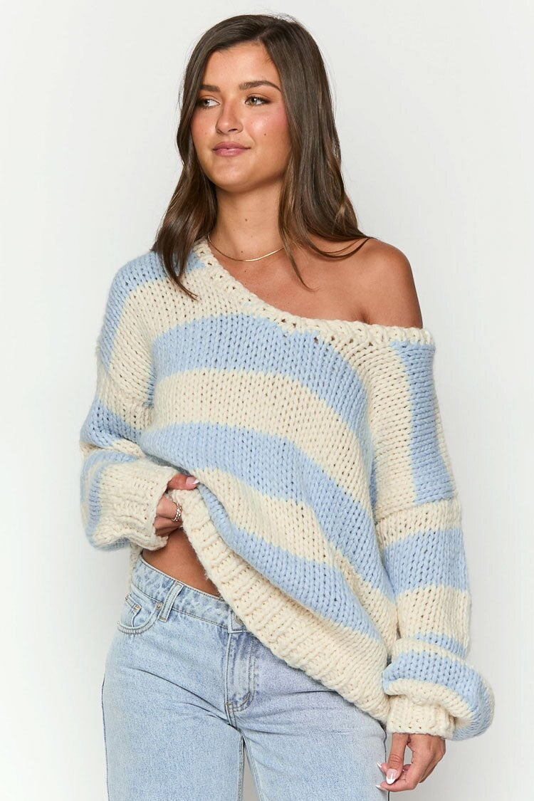 Cozy striped knit sweater with off-the-shoulder design. Chic autumn sweater. 