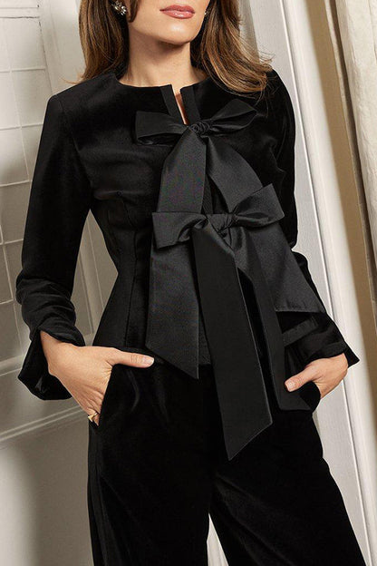Peplum jacket in bespoke taffeta with velvet bow detail 
