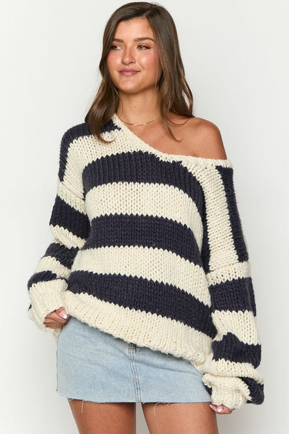 Cozy knitted sweater with an off-the-shoulder striped pattern 
