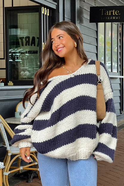 Cozy knitted sweater with an off-the-shoulder striped pattern 