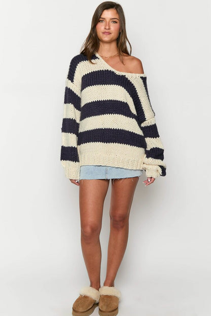 Cozy striped knit sweater with off-the-shoulder design. Chic autumn sweater. 